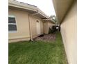 Side yard with a pathway leading to a private gated entrance at 2253 Heron Cir, Clearwater, FL 33762