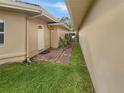 Side yard with a pathway leading to a private gated entrance at 2253 Heron Cir, Clearwater, FL 33762