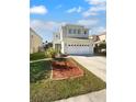 Two story house with a two-car garage and manicured lawn at 9301 Wellstone Dr, Land O Lakes, FL 34638