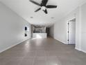 Bright living room features tile flooring and a ceiling fan at 6223 Springmont Loop, Palmetto, FL 34221