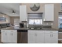 Modern kitchen with white cabinets, granite counters, and stainless steel appliances at 1315 Gangplank Dr, Valrico, FL 33594