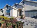 Front view of two-story house with gray garage and walkway at 7006 162Nd E Pl, Parrish, FL 34219