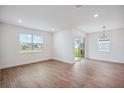 Bright dining room with sliding glass doors and modern light fixture at 117 Runaway Field Ave, Nokomis, FL 34275