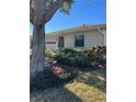 Well-maintained house exterior featuring a two-car garage and lush landscaping at 2513 Lancaster Dr, Sun City Center, FL 33573