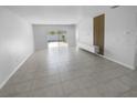 Open concept living area with tile floors and plenty of natural light at 17827 Turning Leaf Cir, Land O Lakes, FL 34638
