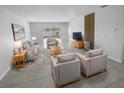 Spacious living room with modern furniture and large sliding glass doors leading to backyard at 17827 Turning Leaf Cir, Land O Lakes, FL 34638