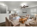 Spacious living room with tile floors, neutral colors, and a ceiling fan at 8863 White Sage Loop, Lakewood Ranch, FL 34202