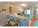Bright kitchen with light cabinets, stainless steel appliances, and a breakfast bar at 3919 Cape Haze Dr # 503, Rotonda West, FL 33947