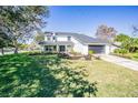 Attractive two-story home with a well-kept lawn and modern black trim at 6370 Conniewood Sq, New Port Richey, FL 34653