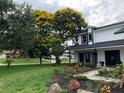 Charming two-story home features mature landscaping with flowering tree, well manicured lawn and attractive curb appeal at 6370 Conniewood Sq, New Port Richey, FL 34653