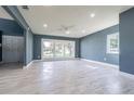 Bright living room featuring large windows and stylish tile flooring at 6370 Conniewood Sq, New Port Richey, FL 34653