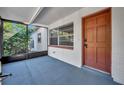 Inviting screened porch entry with updated door and window at 990 Sunrise Dr, Tarpon Springs, FL 34689
