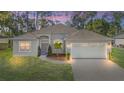 A charming one-story house with a two-car garage and well-manicured lawn at 5277 Epping Ln, Zephyrhills, FL 33541