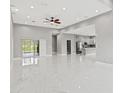 Spacious living room with marble floors, recessed lighting, and access to the outdoor patio at 5277 Epping Ln, Zephyrhills, FL 33541