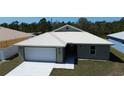 Inviting single-story home with a spacious driveway, two-car garage, and modern metal roof at 12263 Cartouche Ave, Punta Gorda, FL 33955