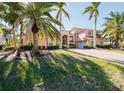 Two story house with palm trees and a brick driveway at 1516 Ridgewood Ln, Sarasota, FL 34231