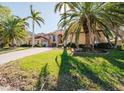 Two story house with palm trees and a brick driveway at 1516 Ridgewood Ln, Sarasota, FL 34231