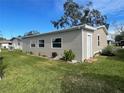 Tan exterior mobile home with landscaping at 3145 Hidden Lake Dr, Wesley Chapel, FL 33543