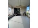 Screened patio with wicker chairs and access to home at 3145 Hidden Lake Dr, Wesley Chapel, FL 33543