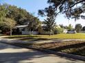 Quaint home with white picket fence, lush landscaping, and convenient driveway parking at 2695 S East Ave, Sarasota, FL 34239