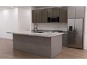 Modern kitchen with a large island, stainless steel appliances, and ample counter space at 11322 Zola Ave, Port Charlotte, FL 33981