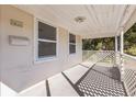 Quaint covered porch with white lattice, offering a relaxing space at 4035 Fairfield S Ave, St Petersburg, FL 33711