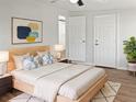 Bright bedroom with light wood flooring and neutral decor at 10009 Connecticut St, Gibsonton, FL 33534