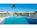 Community pool with surrounding patio furniture at 6809 9Th W Ave # 0, Bradenton, FL 34209