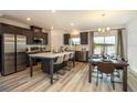 Modern kitchen with island, stainless steel appliances, and breakfast nook at 32094 Eastern Redbud Br, San Antonio, FL 33576