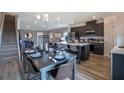 Open kitchen with island and breakfast bar, flows into dining and living areas at 32094 Eastern Redbud Br, San Antonio, FL 33576