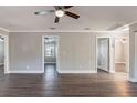 Open-concept living room with wood-look floors and access to other rooms at 2558 12Th S Ave, St Petersburg, FL 33712