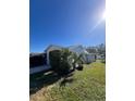 Side view of the single-story home with a fenced backyard and landscaping at 5770 46Th N Ave, Kenneth City, FL 33709