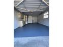 One-car garage interior with laundry area, storage, and painted floor at 5770 46Th N Ave, Kenneth City, FL 33709