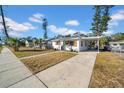 Inviting home with teal front door, wooden shutters, and a spacious driveway at 753 37Th S Ave, St Petersburg, FL 33705