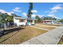 White home with teal door and carport, situated on a corner lot at 753 37Th S Ave, St Petersburg, FL 33705