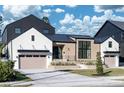 This modern home boasts a striking combination of brick, white siding, and a black metal roof, complemented by a neat lawn at 1046 Snell Isle Ne Blvd, St Petersburg, FL 33704