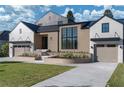 Modern home with brick and white siding, a black metal roof, and a well-manicured lawn at 1046 Snell Isle Ne Blvd, St Petersburg, FL 33704