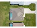 Aerial view of the house showcasing the roof, screened-in pool, and brick driveway at 243 Rotonda S Blvd, Rotonda West, FL 33947