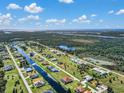 Stunning aerial view showcasing a canal-front property in a picturesque community with lush greenery at 243 Rotonda S Blvd, Rotonda West, FL 33947