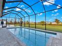 Screened-in pool with a view of the community and golf course at 243 Rotonda S Blvd, Rotonda West, FL 33947