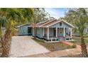 Charming blue craftsman-style home featuring a cozy front porch and a well-maintained, xeriscaped front yard at 2514 Beach S Blvd, Gulfport, FL 33707