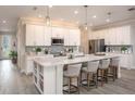 Modern kitchen with white shaker cabinets, quartz countertops, stainless steel appliances, and a large island at 2550 Mauritania Rd, Punta Gorda, FL 33983