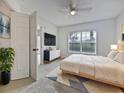 Bedroom with plush carpet, a ceiling fan, and large window with blinds at 2061 Willow Hammock Cir # 107, Punta Gorda, FL 33983