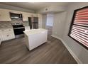 Updated kitchen with stainless steel appliances, a white island, and wood-look flooring at 314 Spring Lakes Blvd # 314-U, Bradenton, FL 34210