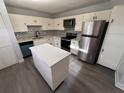 Modern kitchen featuring stainless steel appliances, white cabinets, and an island at 314 Spring Lakes Blvd # 314-U, Bradenton, FL 34210