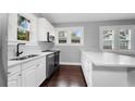 Bright kitchen with white cabinets, stainless steel appliances, and ample counter space at 603 W Emma St, Tampa, FL 33603
