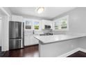 Updated kitchen featuring white cabinets, stainless steel appliances, and a white countertop at 603 W Emma St, Tampa, FL 33603