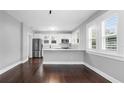 Modern kitchen with white cabinets, stainless steel appliances, and dark wood floors at 603 W Emma St, Tampa, FL 33603