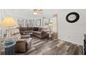 Cozy living room with a comfortable sectional sofa, neutral decor, and ample natural light at 4920 Sedeno Dr, Zephyrhills, FL 33541