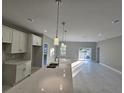 Modern kitchen with white cabinets, quartz countertops, and island at 2840 S Biscayne Dr, North Port, FL 34287